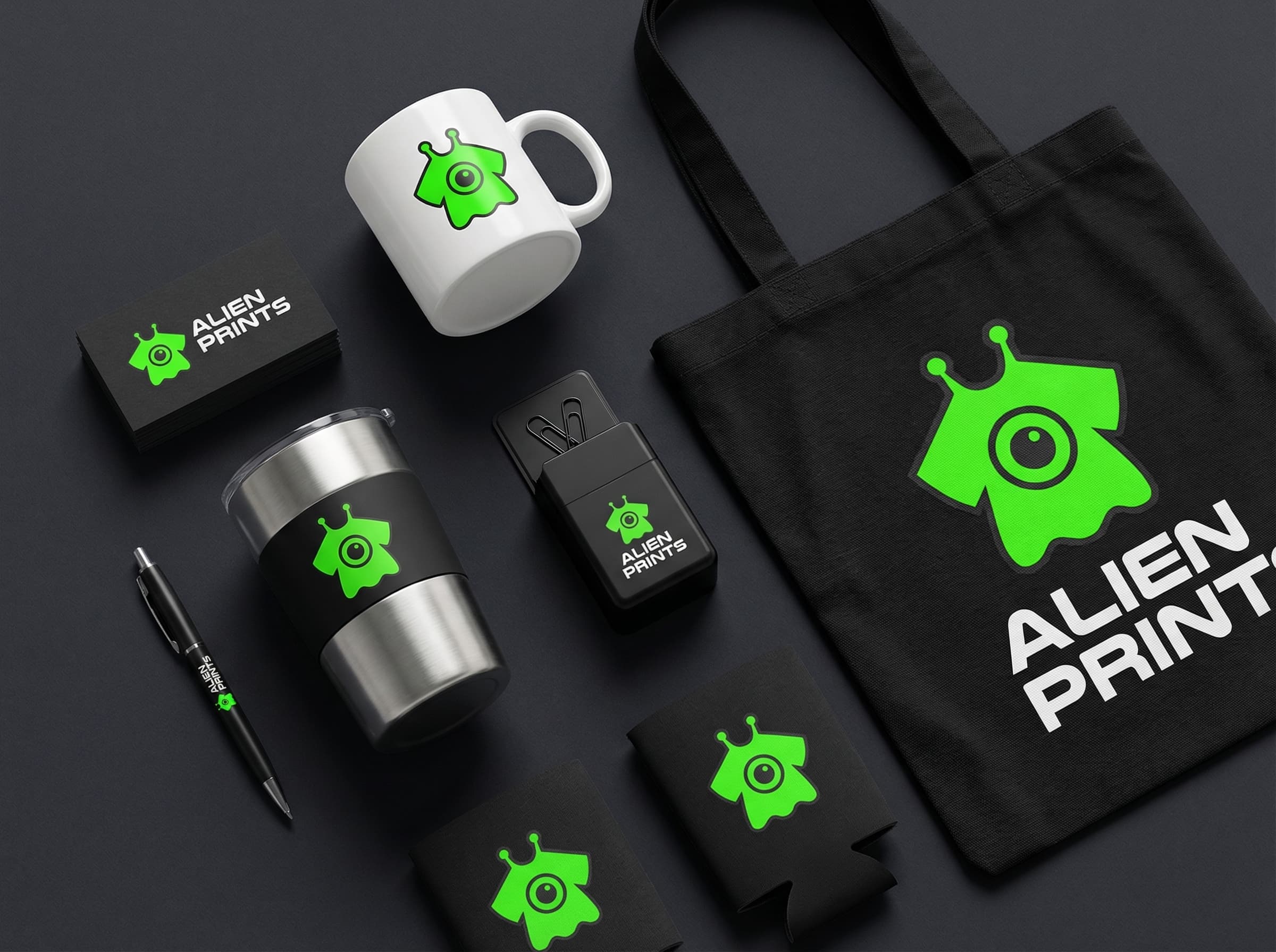 Alien Prints branded promotional products including mugs, tumblers, business cards, tote bags, and koozies